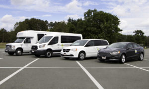 Kiessling Transit's Fleet - Four Vehicles in Parking Lot